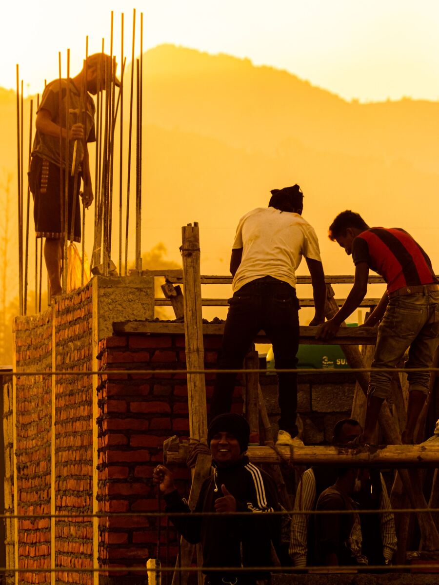 A building crew working at golden hour