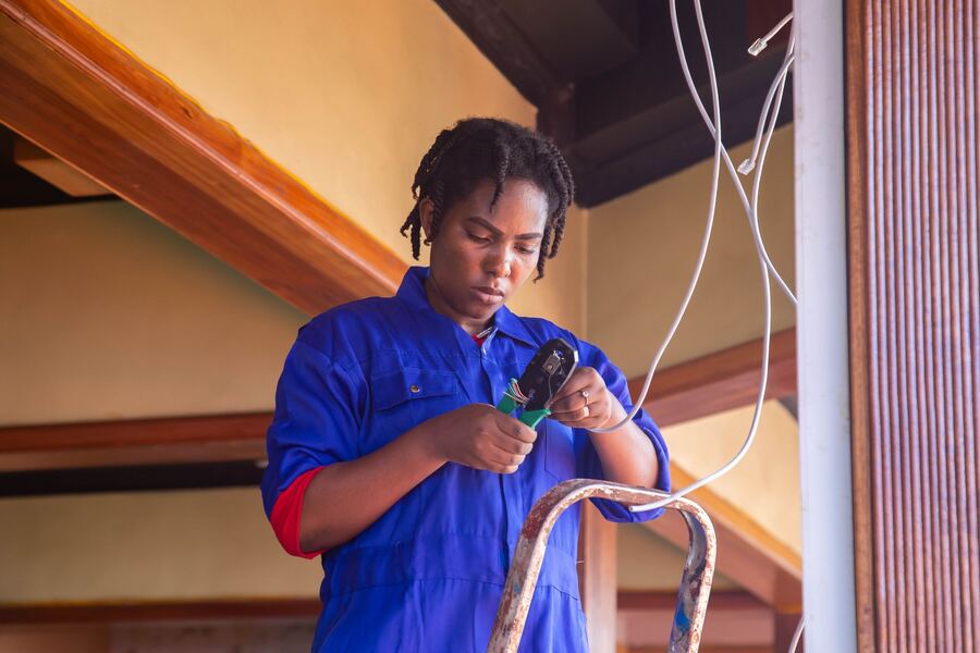 An electrician stripping wiring indoors